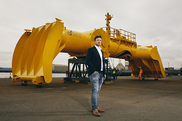 Mocean Energy’s Managing Director Cameron McNatt with Mocean Energy's Blue X wave energy converter at Forth Ports’ Rosyth Docks.